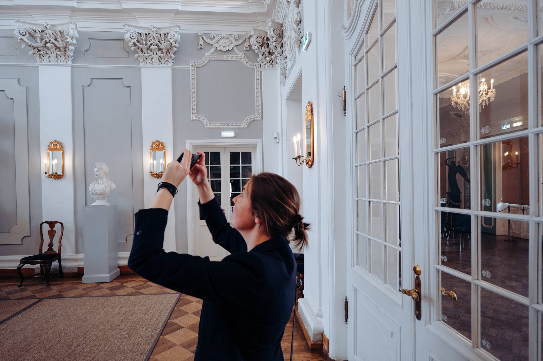 Woman taking a photo at the main hall of the Kadiorg Palace in Tallinn, Estonia