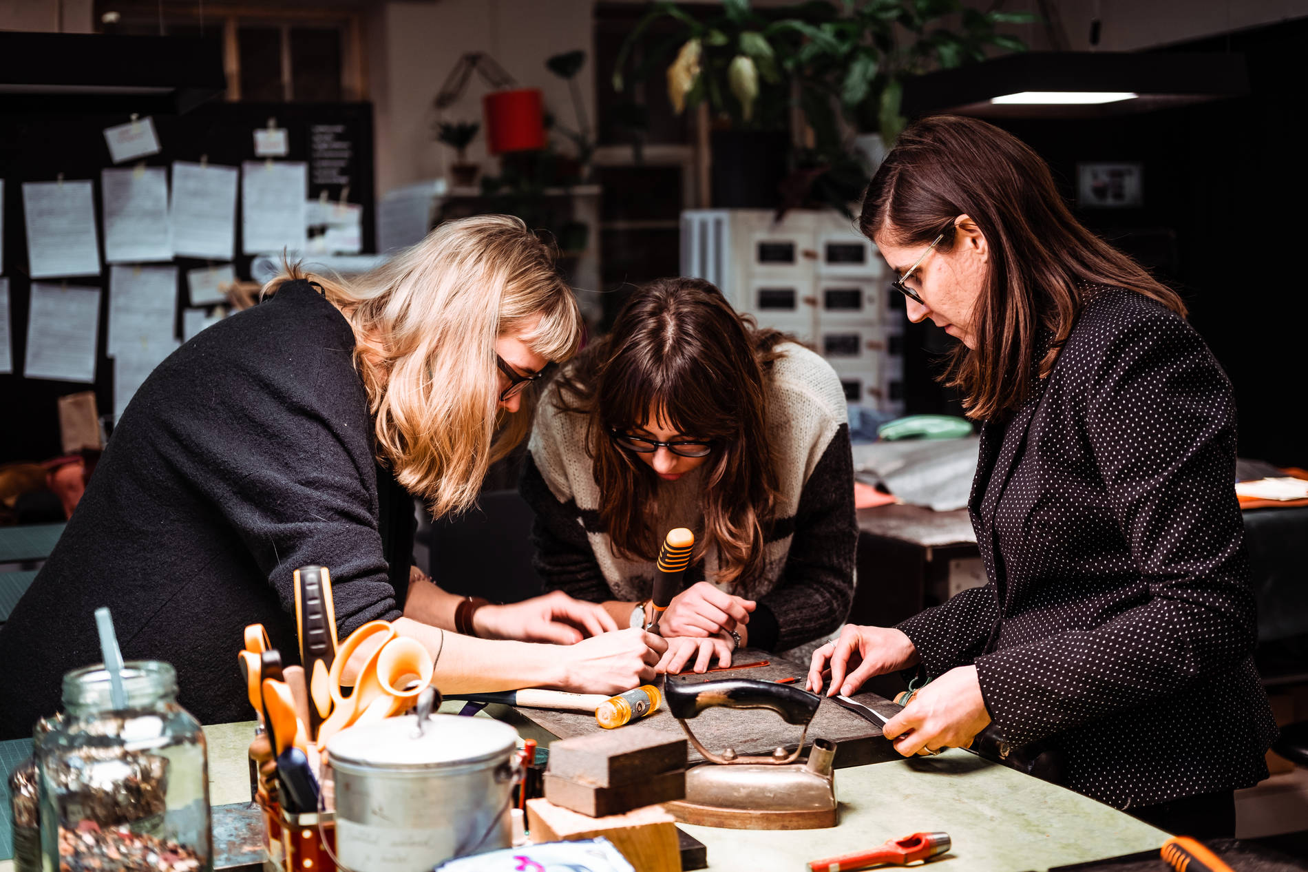 People crafting with leather at the Stella Soomlais leather workshop. Photo by: Kadi-Liis Koppel 
