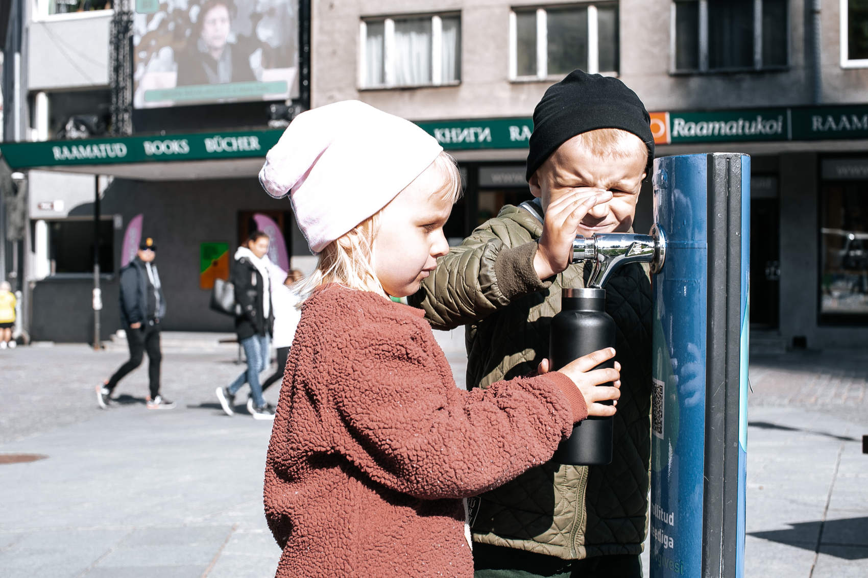 Children using public water tap in Tallinn, Estonia Photo: Kairi Tähe