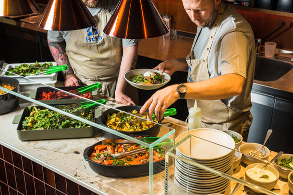 A chef prepares food at a restaurant at the Viru Keskus food hall